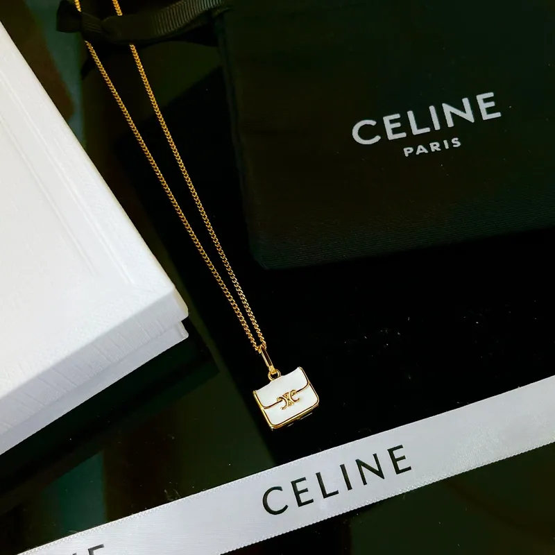 Rectangular pendant necklace; gold tone, sculptural design. Full-frame photograph with existing branding.
