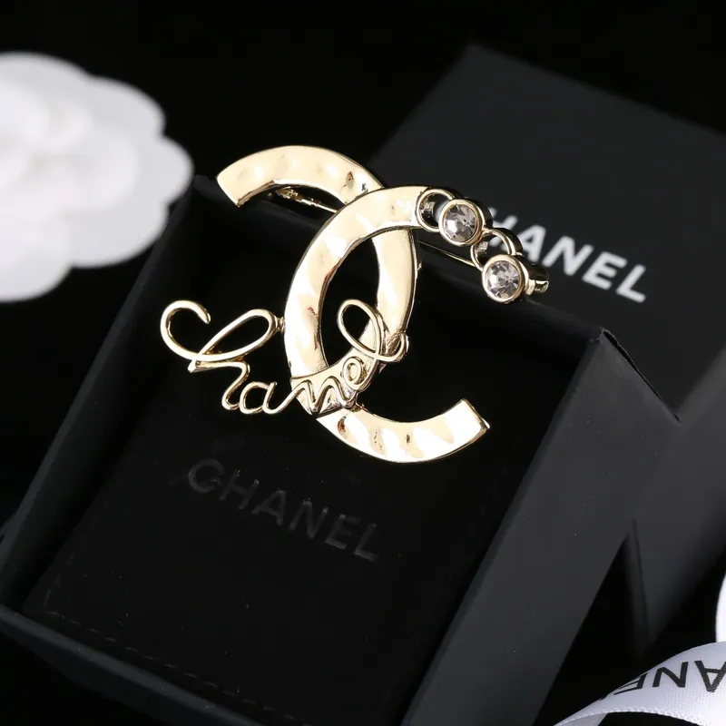 Pearl-look accent brooch; gold tone, pearl accents design. Full-frame photograph with existing branding.