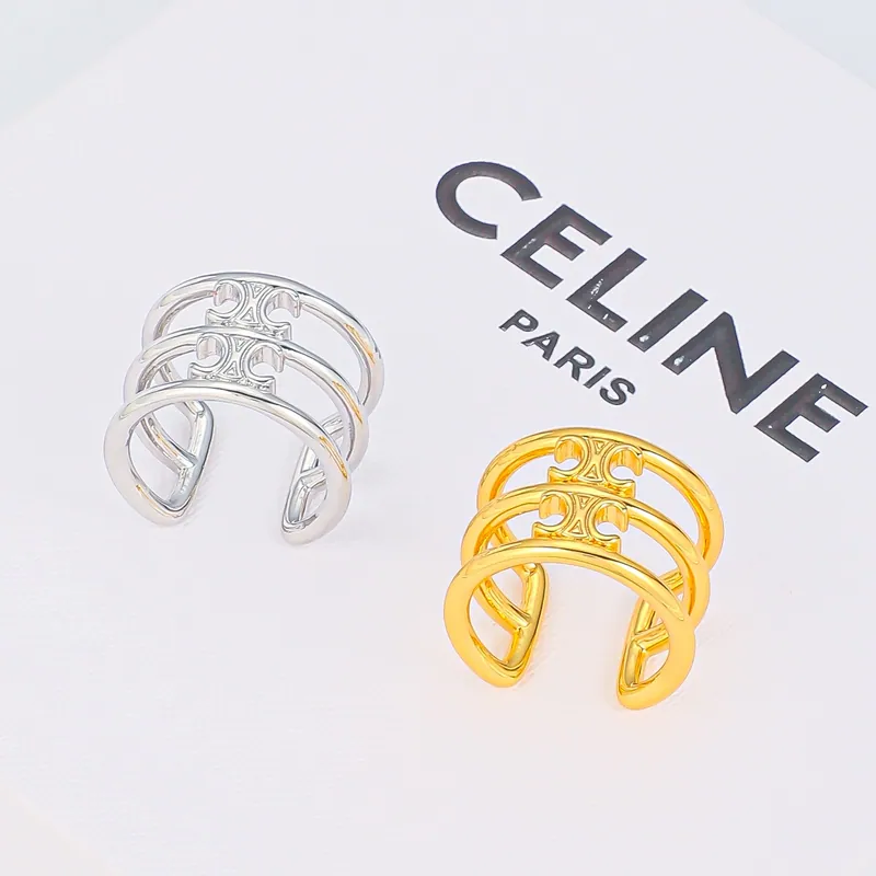 Openwork sculptural rings; mixed tones, sculptural design. Full-frame photograph with existing branding.