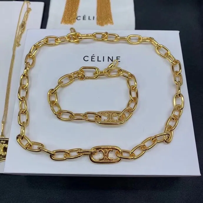 Oval-link necklace & bracelet; gold tone, sculptural design. Full-frame photograph with existing branding.