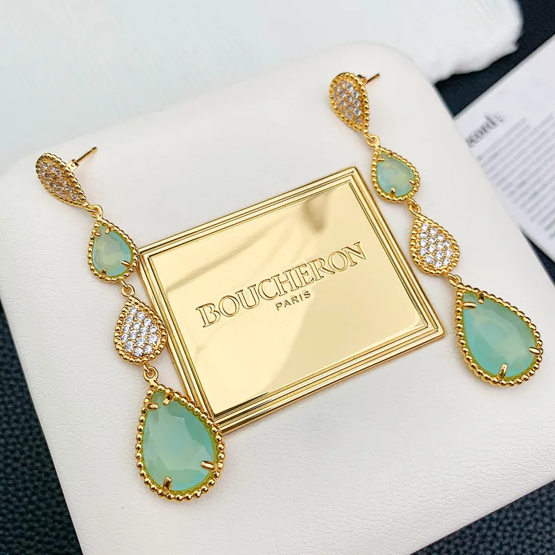 Mint teardrop bracelet; gold tone, botanical design. Full-frame photograph with existing branding.