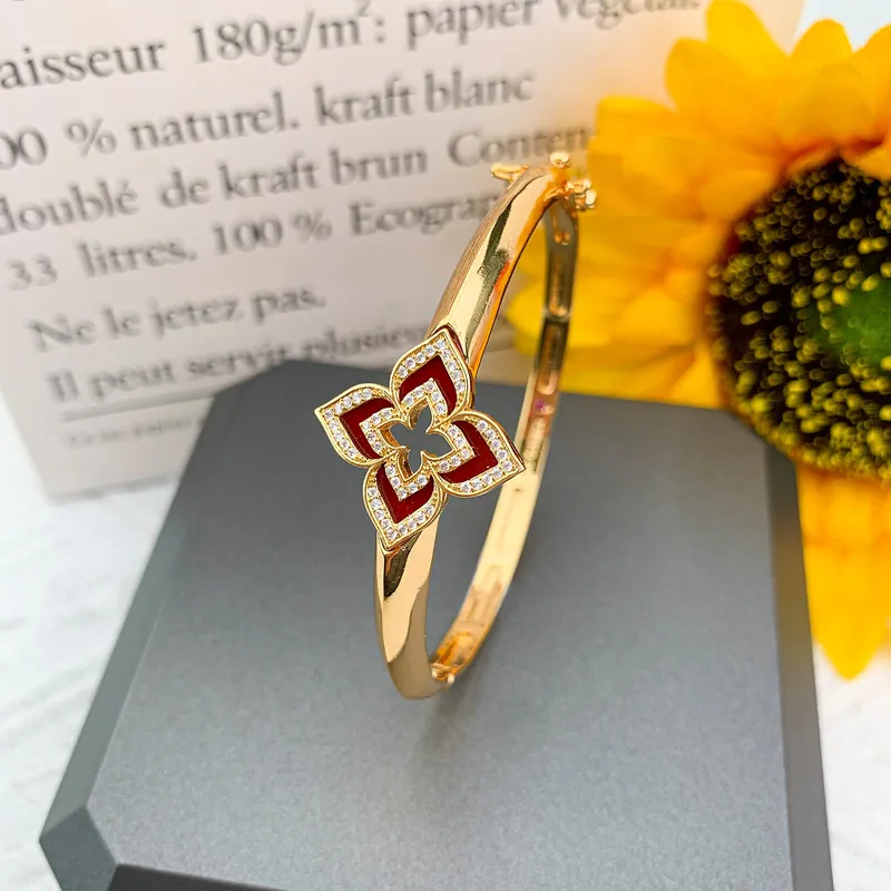 Open floral ring; gold tone, botanical design. Full-frame photograph with existing branding.