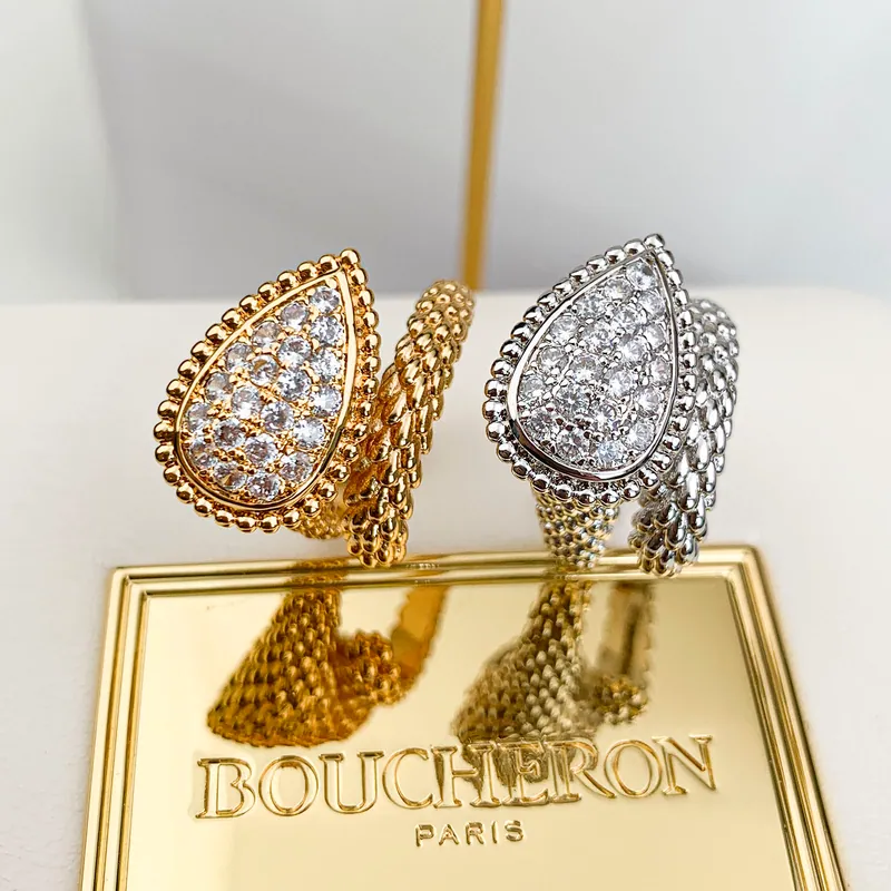 Textured teardrop earrings; mixed tones, statement design. Full-frame photograph with existing branding.